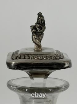 Antique Indonesian liqueur set with silver deity motifs, crystal decanter, and goblets