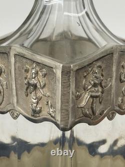 Antique Indonesian liqueur set with silver deity motifs, crystal decanter, and goblets