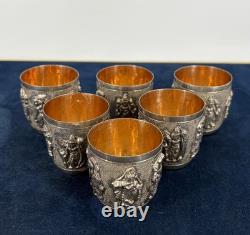 Antique Indonesian liqueur set with silver deity motifs, crystal decanter, and goblets