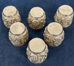 Antique Indonesian liqueur set with silver deity motifs, crystal decanter, and goblets