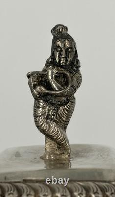 Antique Indonesian liqueur set with silver deity motifs, crystal decanter, and goblets