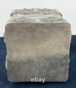 Antique Indonesian liqueur set with silver deity motifs, crystal decanter, and goblets