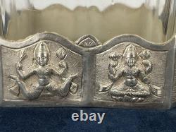 Antique Indonesian liqueur set with silver deity motifs, crystal decanter, and goblets