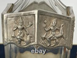 Antique Indonesian liqueur set with silver deity motifs, crystal decanter, and goblets