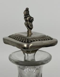 Antique Indonesian liqueur set with silver deity motifs, crystal decanter, and goblets