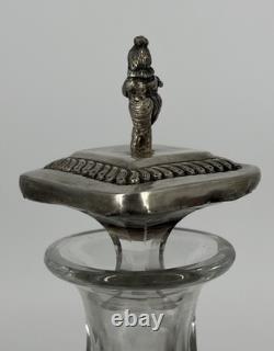 Antique Indonesian liqueur set with silver deity motifs, crystal decanter, and goblets