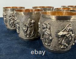 Antique Indonesian liqueur set with silver deity motifs, crystal decanter, and goblets