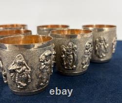 Antique Indonesian liqueur set with silver deity motifs, crystal decanter, and goblets