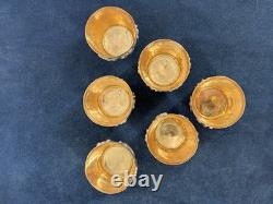 Antique Indonesian liqueur set with silver deity motifs, crystal decanter, and goblets