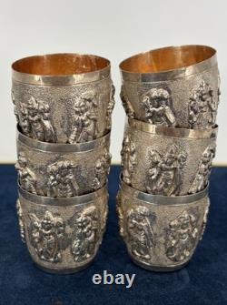 Antique Indonesian liqueur set with silver deity motifs, crystal decanter, and goblets