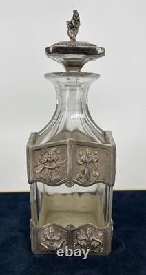 Antique Indonesian liqueur set with silver deity motifs, crystal decanter, and goblets