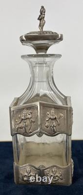 Antique Indonesian liqueur set with silver deity motifs, crystal decanter, and goblets