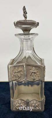 Antique Indonesian liqueur set with silver deity motifs, crystal decanter, and goblets