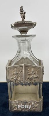 Antique Indonesian liqueur set with silver deity motifs, crystal decanter, and goblets