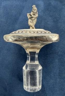 Antique Indonesian liqueur set with silver deity motifs, crystal decanter, and goblets