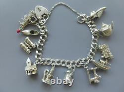 Antique silver bracelet with hallmarks, 13 assorted charms, approximately 36g, about 18cm long