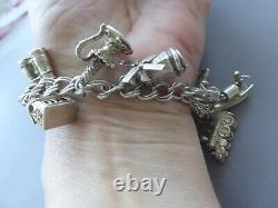 Antique silver bracelet with hallmarks, 13 assorted charms, approximately 36g, about 18cm long