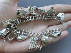 Antique silver bracelet with hallmarks, 13 assorted charms, approximately 36g, about 18cm long
