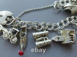 Antique silver bracelet with hallmarks, 13 assorted charms, approximately 36g, about 18cm long