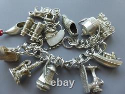 Antique silver bracelet with hallmarks, 13 assorted charms, approximately 36g, about 18cm long