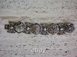Antique solid silver bracelet with fleur-de-lys, lion, and cherub crest