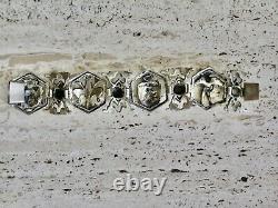 Antique solid silver bracelet with fleur-de-lys, lion, and cherub crest