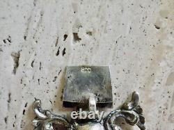 Antique solid silver bracelet with fleur-de-lys, lion, and cherub crest