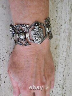 Antique solid silver bracelet with fleur-de-lys, lion, and cherub crest