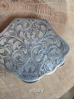 Antique solid silver powder box with finely carved floral decoration.