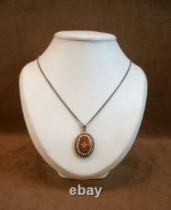 Old antique pendant in solid silver and Bressan enamels, red background