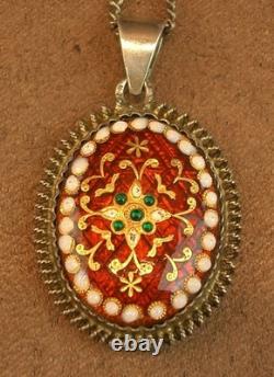 Old antique pendant in solid silver and Bressan enamels, red background