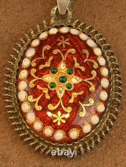 Old antique pendant in solid silver and Bressan enamels, red background