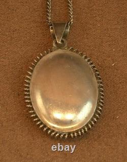 Old antique pendant in solid silver and Bressan enamels, red background